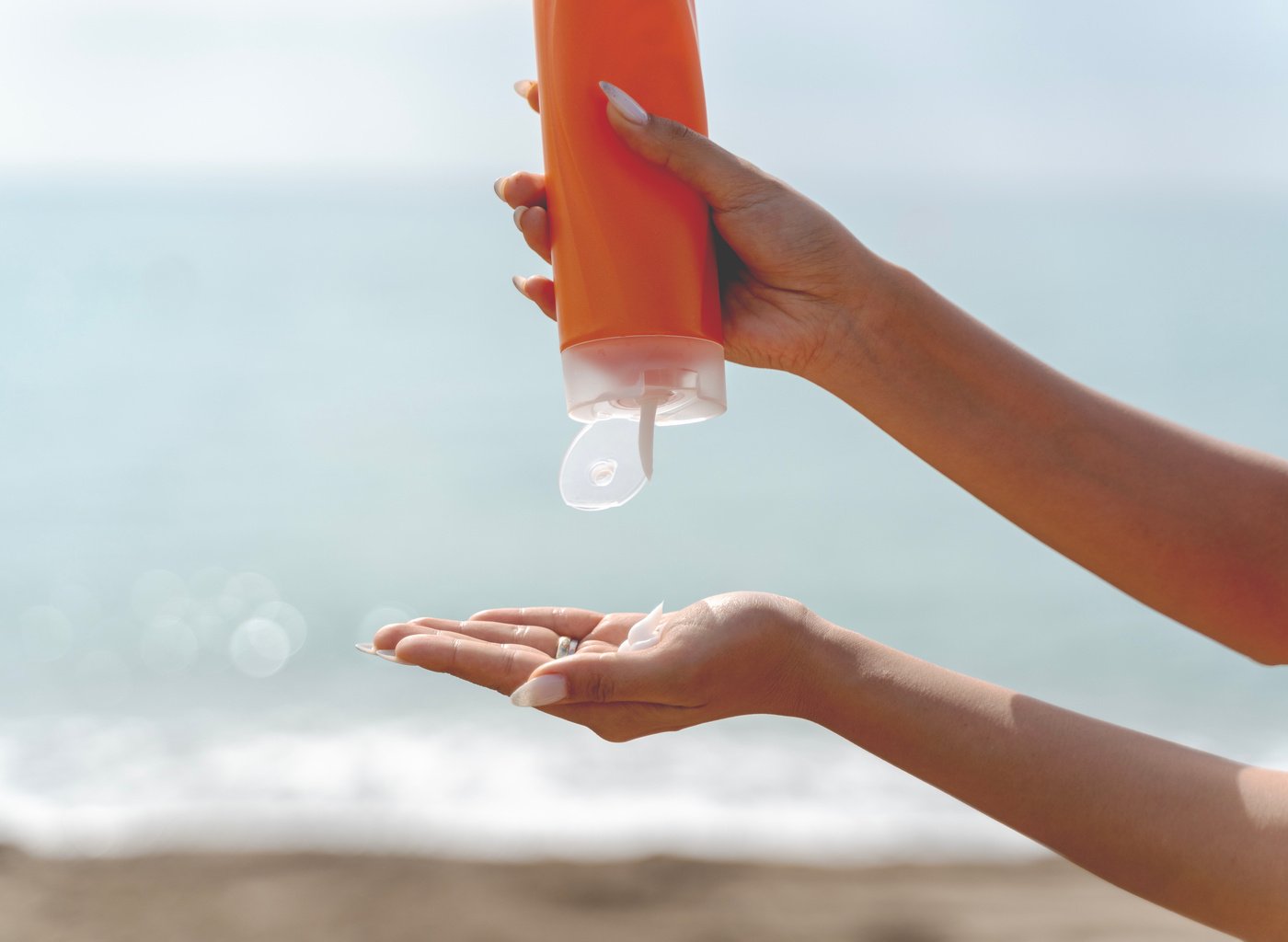 Woman hand apply sunscreen